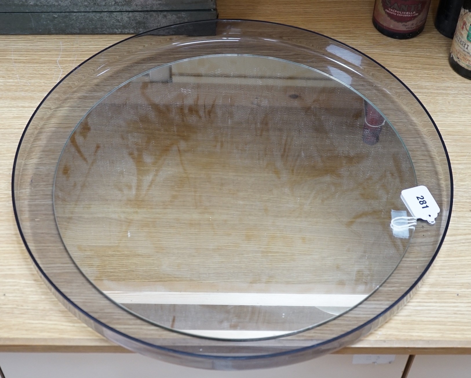 An Italian 1970's circular perspex wall mirror by Guzzini, designed by L. Massoni, 56.5cms diameter